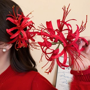 Detail shot of the realistic red lycoris flower hair clip with delicate curved petals
