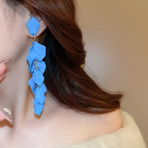 Close-up of blue rose petal tassel earrings on a model showing elegant fringe detail