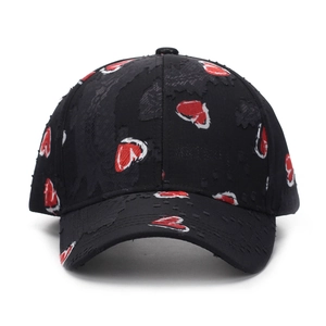 Distressed black baseball cap with red heart pattern and frayed edge details