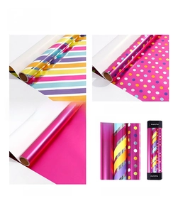 Detail of colorful striped and polka dot metallic wrapping paper rolls for gifts