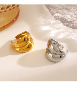 Close-up of gold and silver irregular layered open rings with high-polish finish