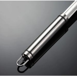 Close-up of brushed stainless steel handle with hanging loop for kitchen oil skimmer