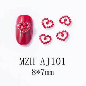 Detailed view of 8x7mm red heart-shaped nail rhinestones with silver metal base