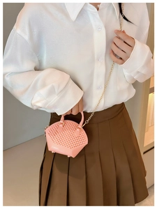 Detailed macro view of pink jelly mini bag with pearl texture and gold chain strap