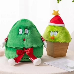 Close-up of green plush Christmas tree toys with red bows in a cozy home setting