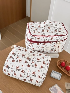 Macro detail of vintage quilted floral corduroy makeup bag set on wooden table