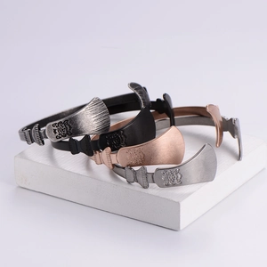Irregular vintage metal bangles in silver, bronze, and black with engraved patterns