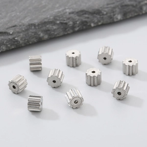 Macro shot of 10 silver stainless steel gear-shaped beads for DIY jewelry making