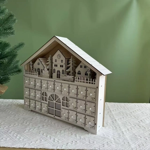 Wooden 24-day advent calendar house with small drawers and festive village silhouette