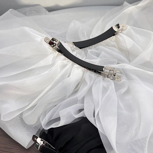 French style oversized chiffon bow hair clips in black and white on a wooden background