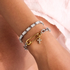 Two-tone paperclip chain bracelet with emerald-cut crystals and a small cross charm