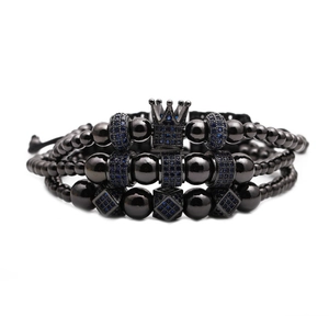 Three-piece black beaded men's bracelet set with blue zircon crown charms on white background