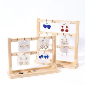 Two-tier wooden jewelry display stand with golden hooks and integrated ring tray base