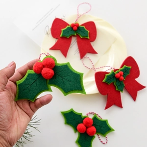 Christmas felt holly leaf and red bow hanging ornaments with festive cotton twine