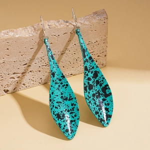 Vintage bohemian turquoise drop earrings with black spots on a natural stone base