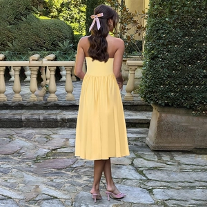 Back view of a French vintage strapless midi dress in light yellow for outdoor vacations