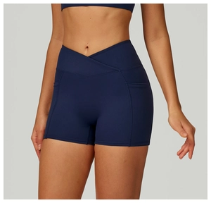 Detail view of high waist crossover waistband and side pockets on navy yoga shorts
