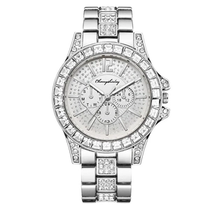 Macro shot of silver stainless steel watch featuring crystal encrusted dial and bezel