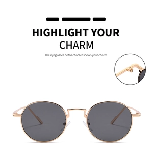 Detailed macro view of the durable gold metal hinge on vintage round sunglasses