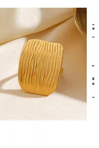 Macro shot of 18K gold plated rectangular ring with deep vertical hand-hammered texture