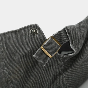 Detail of vintage washed gray newsboy cap featuring brass metal adjustment buckle