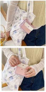 Macro detail of macaron purple coin purse with snap closure and matching floral tote bag