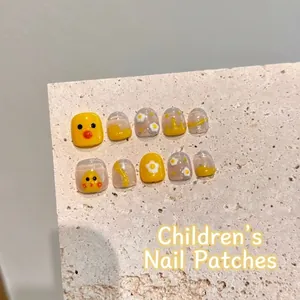 Kids' yellow duck press-on toenails set with small white floral designs and glossy finish
