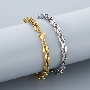Detailed view of gold and silver titanium steel chain bracelets with lobster clasps