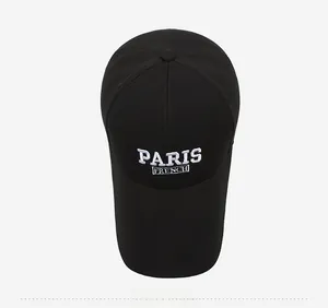Top view showing detailed white PARIS FRENCH embroidery on a black cotton baseball cap