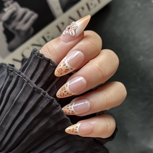 French leopard print almond press-on nails with 3D silver flower and red crystal accents
