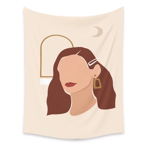 Detail of bohemian tapestry featuring abstract female silhouette and gold crescent moon