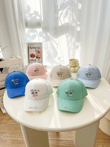 Close-up of kids' mesh baseball caps with animal embroidery in six pastel colors