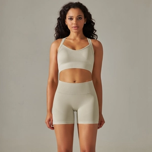 Olive green seamless yoga set with cross-back sports bra and high-waist peach lift shorts
