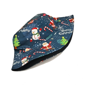 Detail of Santa Claus and snowman patterns on a blue Christmas bucket hat fabric