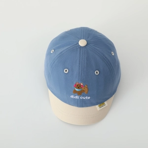 Close-up of contrast baby baseball cap featuring puppy embroidery and fine stitching detail