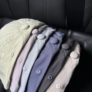 Top view of baseball caps in six colors showing cotton twill fabric and ventilation eyelets