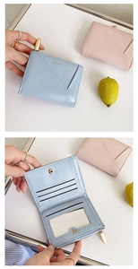 Detail of bifold women's wallet with multiple card slots and secure zipper pocket