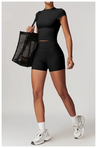 Close-up of black high-elasticity sports set with cropped t-shirt and high-waist shorts