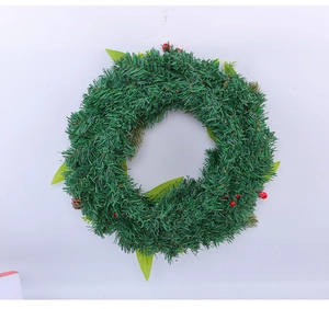 Close-up of green artificial Christmas wreath with red berries and lush PVC foliage