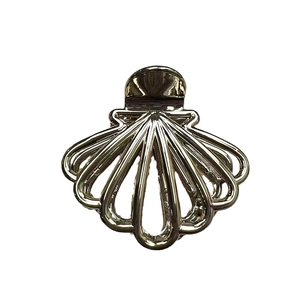 Polished silver shell shaped metal hair claw clip for women on white background