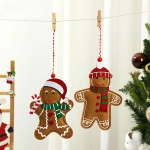 Christmas felt gingerbread man ornaments hanging on string for festive tree decoration