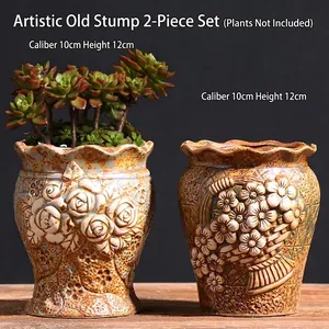 Macro shot of two vintage embossed ceramic succulent pots with floral relief texture
