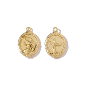 Detail of golden mermaid pendants featuring embossed profile and tail in stainless steel