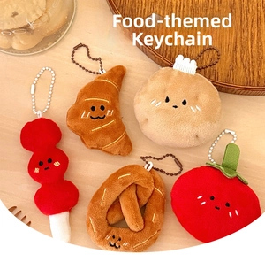 Detailed view of assorted plush food keychains like croissants on a wooden tray