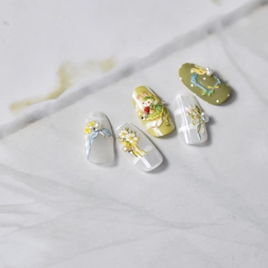 Detail of 3D bunny embossed nail stickers with green floral patterns and pearls