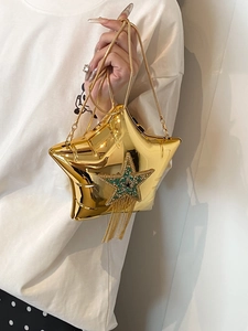 Detail view of a gold star evening bag with sparkling tassels and crystal accents