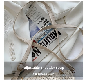 Detail of adjustable leather strap and pearl accents on the beige woven straw bag