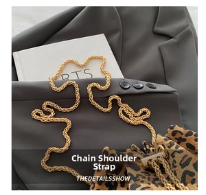 Detailed close-up of the leopard print bucket bag featuring a woven gold chain strap