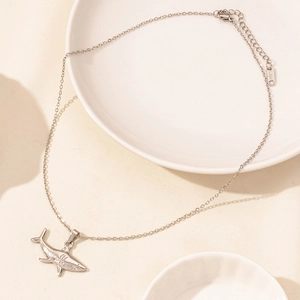 Detail of silver shark pendant with S.STEEL hallmark on stainless steel chain link