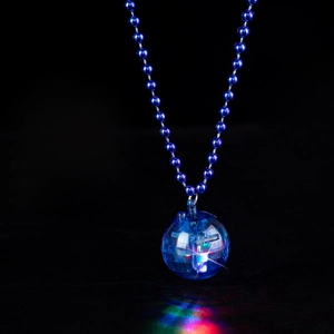 Close-up of a glowing LED disco ball necklace with colorful lights and a blue beaded chain